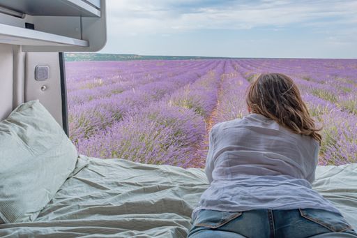 A woman looking at lavender fields from a camper