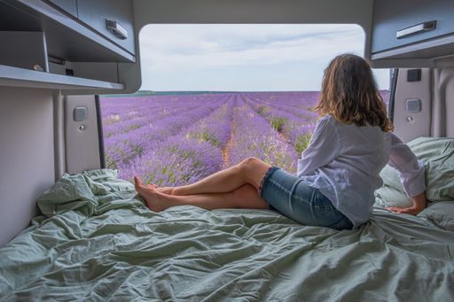 A woman looking at lavender fields from a camper