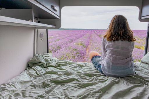 A woman looking at lavender fields from a camper