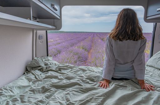 A woman looking at lavender fields from a camper