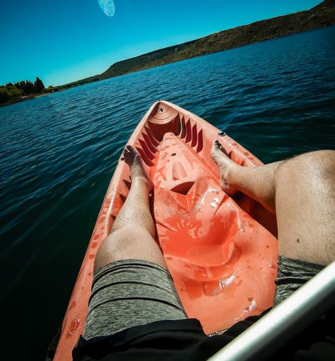A vertical shot of male feet on the boat