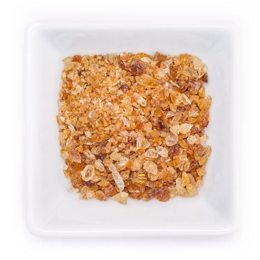 A top view of brown candy sugar in a white bowl