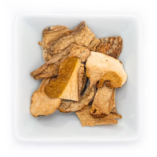 A top view of dried porcini in a white bowl