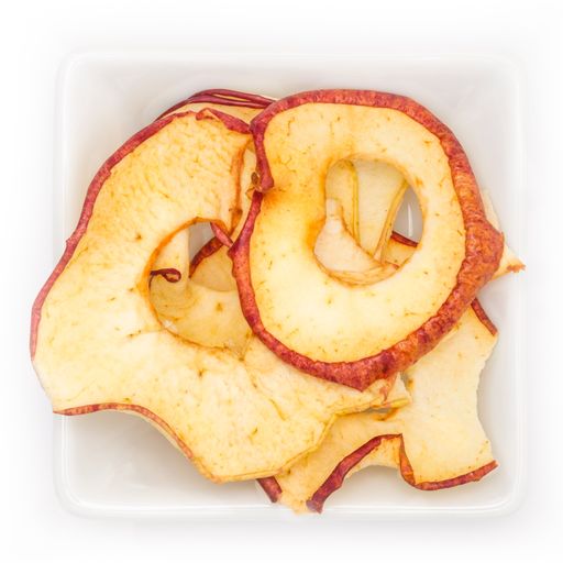 A top view of dried apple rings in a white bowl