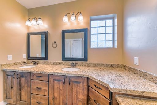 An image of a wooden bathroom with a nice good lighting.