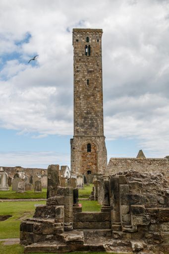 A vertical shot of a tower and ruins of the famous historic St Andrews Cathedral under a blue cloudy sky