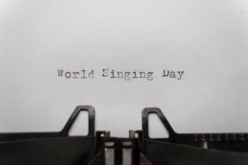vintage world singing day typed words on a typewriter