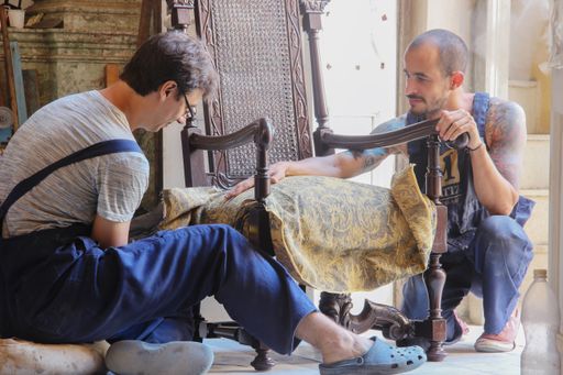 A closeup shot of two Hispanic males working in their workshop during the day
