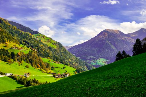 A landscape of alps covered in greenery under the sunlight in South Tyrol in Italy