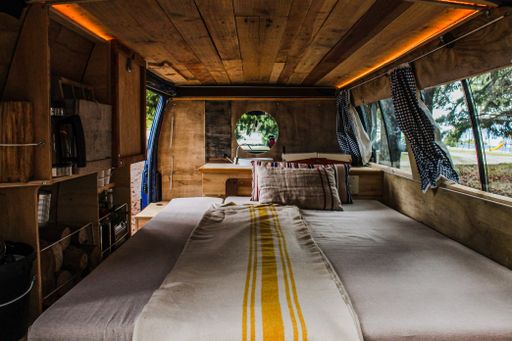 A beautiful view of bed inside a vintage wooden van