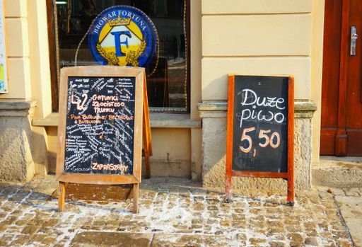 A two chalkboards with offers in front of the bar on the old square