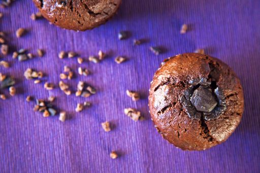 A top view shot of chocolate muffins on a purple background