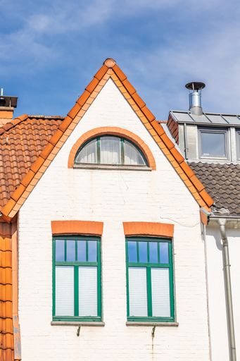 A vertical shot of a colorful building in the background of blue sky