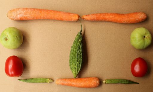 A top view of fresh and healthy vegetables on a brown surface