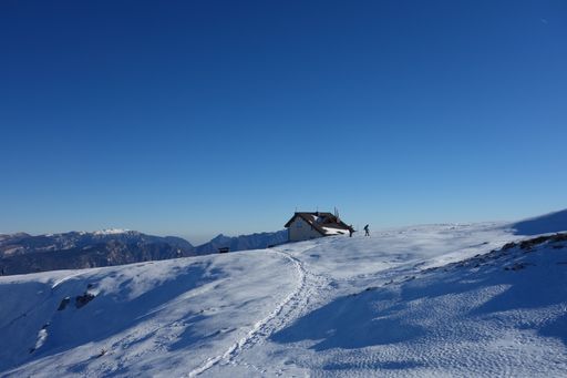 A house on a snowy top of a lofty mountain