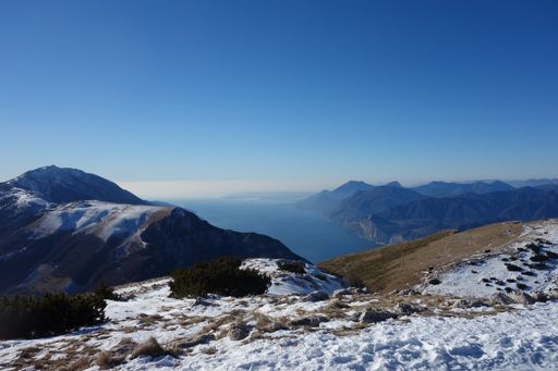 A slope of a bare mountain with a snowy top in the morning