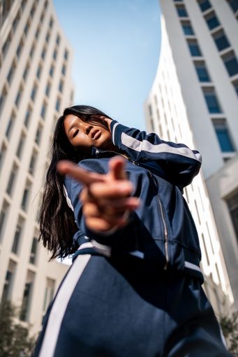 An attractive Asian woman in sportswear posing in the street