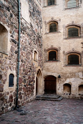 The facade of Turku Castle in Turku, Finland against a cloudy sky