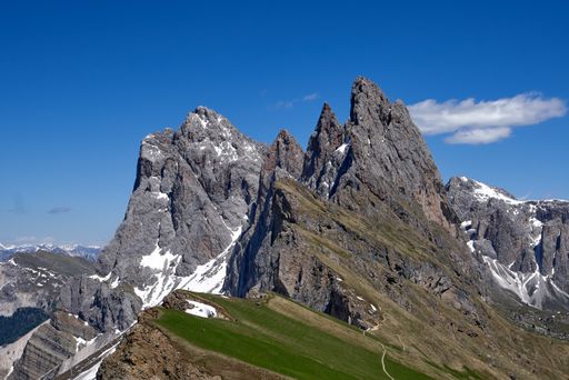 A beautiful shot of high scenic rocks on the background of clear blue sky.