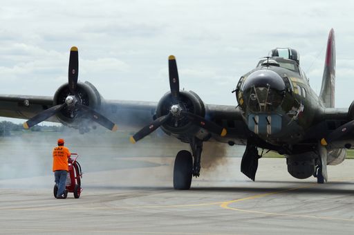 A horizontal shot of a B-17 bomber airplane preparing for flight