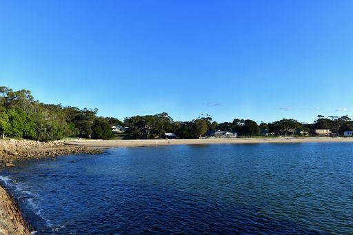 A landscape of the Bundeena Beach surrounded by the sea on a sunny day in the Royal National Park, Sydney, Australia