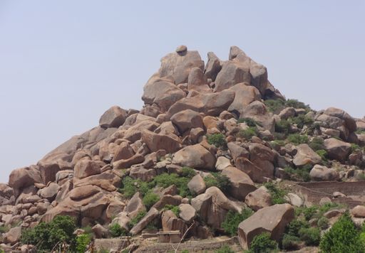 A View of Rocky Mountain with large boulders all over the Mountain on Sunny day  in India