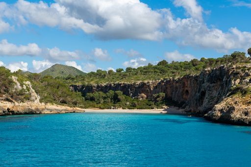Cala Magraner Bay in Mallorca with Blue Sky and Morning Sunlight