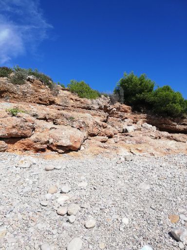 A tranquil landscape of a cliff dwelling in daylight
