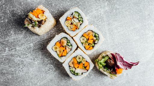 A top view of appetizing sushi rolls on a gray surface