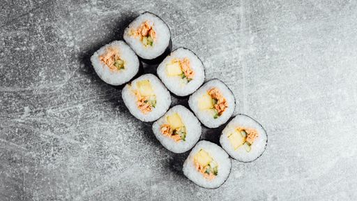 A top view of appetizing sushi rolls "Tomago Maki" on a gray surface