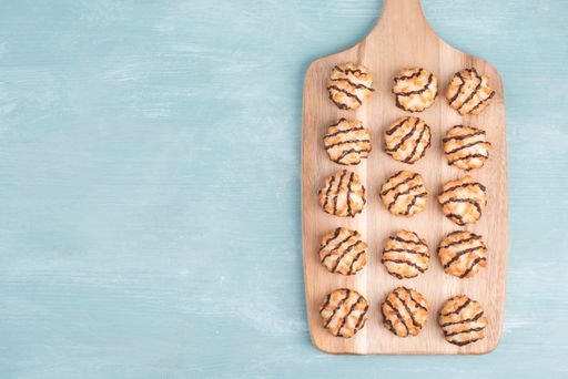 Coconut macaroons on a textured blue background, sweets christmas time