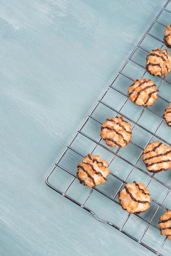 Coconut macaroons on a textured blue background, sweets christmas time