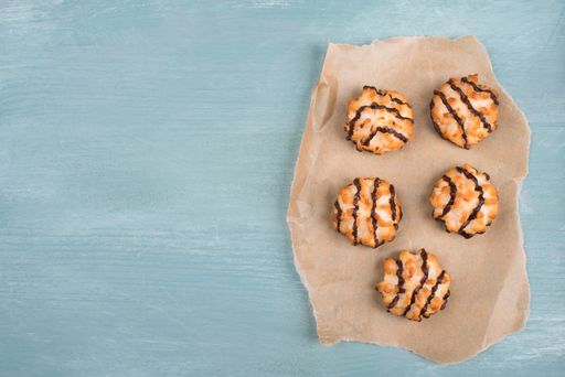 Coconut macaroons on a textured blue background, sweets christmas time