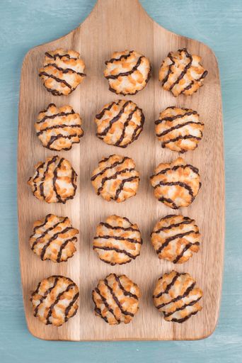 Coconut macaroons on a textured blue background, sweets christmas time