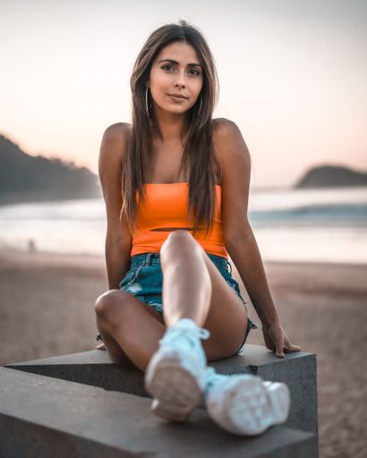 A vertical shot of a beautiful brunette in Zarautz, Spain