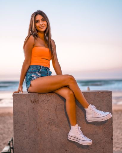 A vertical shot of a beautiful brunette in Zarautz, Spain