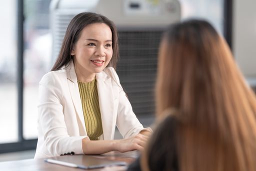 A horizontal shot of an Asian beautiful female meeting with their tutor