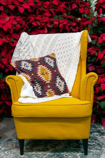 A vertical shot of a cozy yellow armchair