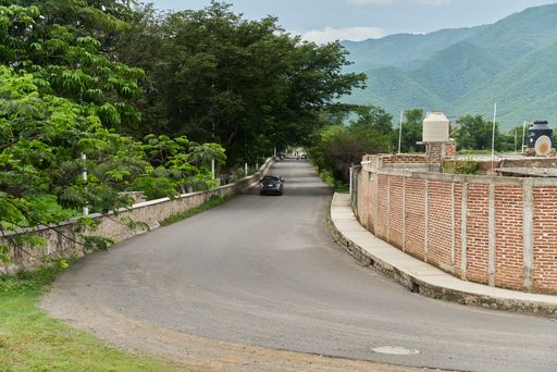 Tight curve of a rural road where small vehicles are traveling