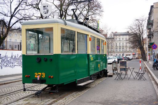 A modern cozy cafe in a green tram at the city center of Poznan during the daytime