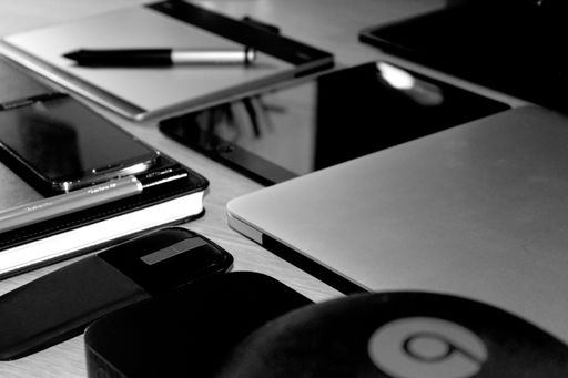 A closeup greyscale shot of technological devices and smartphones