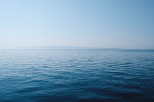 A stunning view of a peaceful ocean with a clear sky