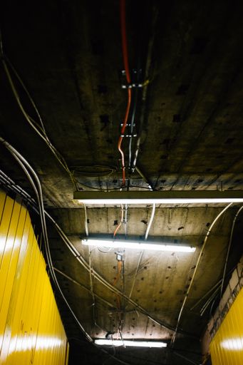 A vertical shot of the tunnel ceiling with electric cables.