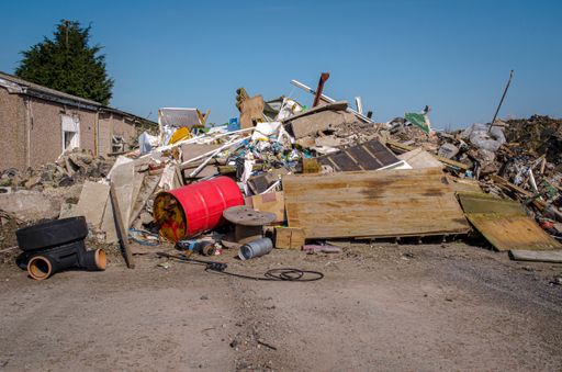 Mounds of demolition rubble and industrial waste at abandoned industrial site