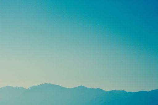 A beautiful shot of peaceful hills and mountains with amazing blue sky in the background