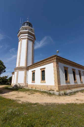 A vertical shot of the Mazagon Picacho) lighthouse near the entrance to the port of Huelva