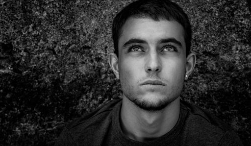 A grayscale shot of a male looking up