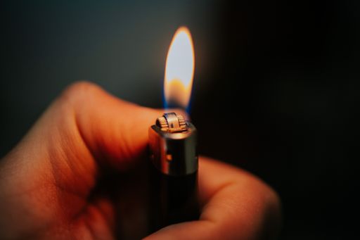 The lighter in the persons hand