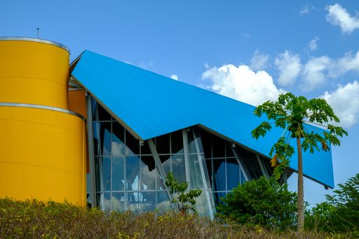 The Biomuseo surrounded by greenery under the sunlight and a blue sky at daytime in Panama