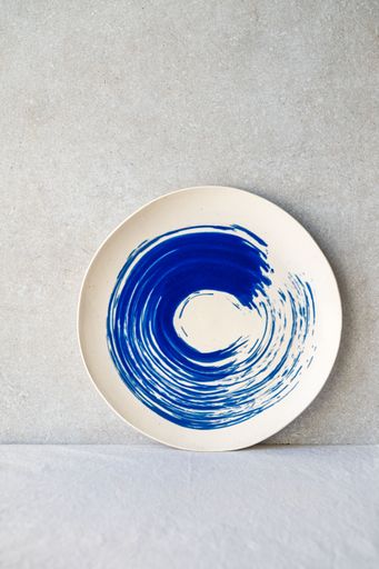 A blue and white ceramic plate with a cobalt oxide wash.